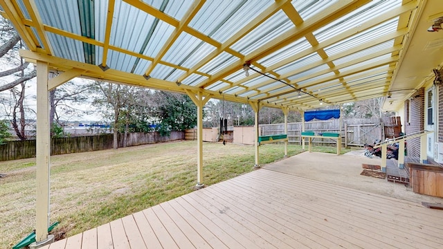 wooden deck with a fenced backyard, a pergola, and a yard