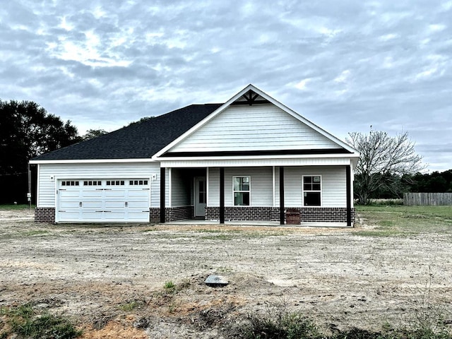 view of front of house with covered porch and a garage