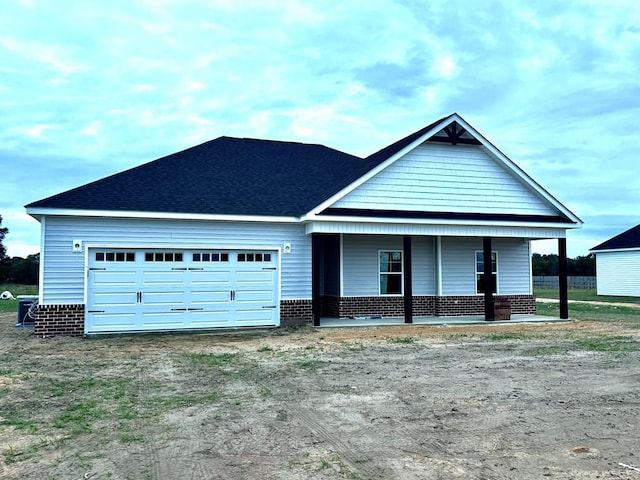 view of front of house featuring covered porch and a garage