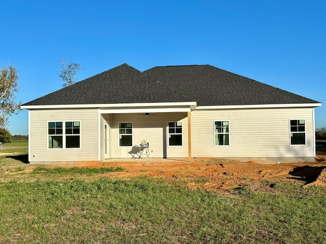 back of house featuring a lawn and a patio area