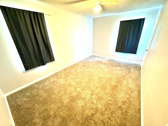 empty room with carpet flooring and ceiling fan