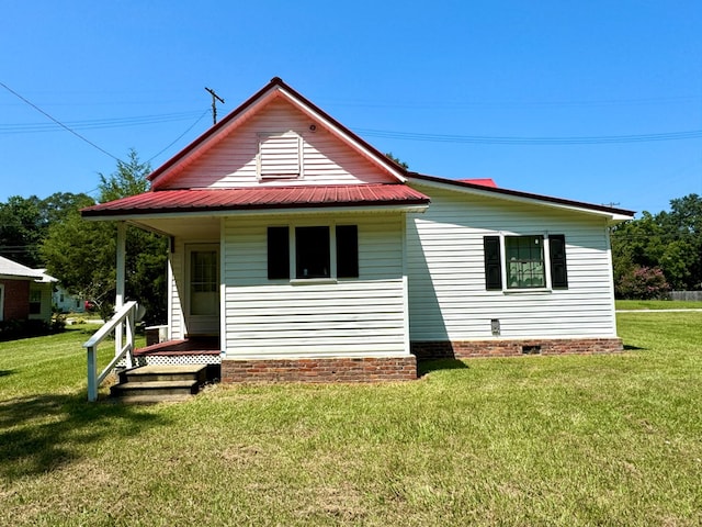 back of house with a lawn and a porch