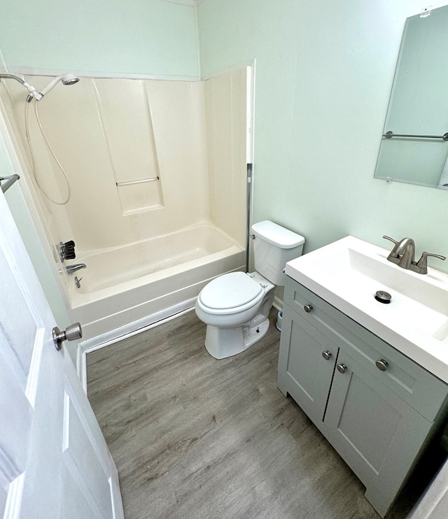 full bathroom featuring vanity, toilet, wood-type flooring, and shower / washtub combination