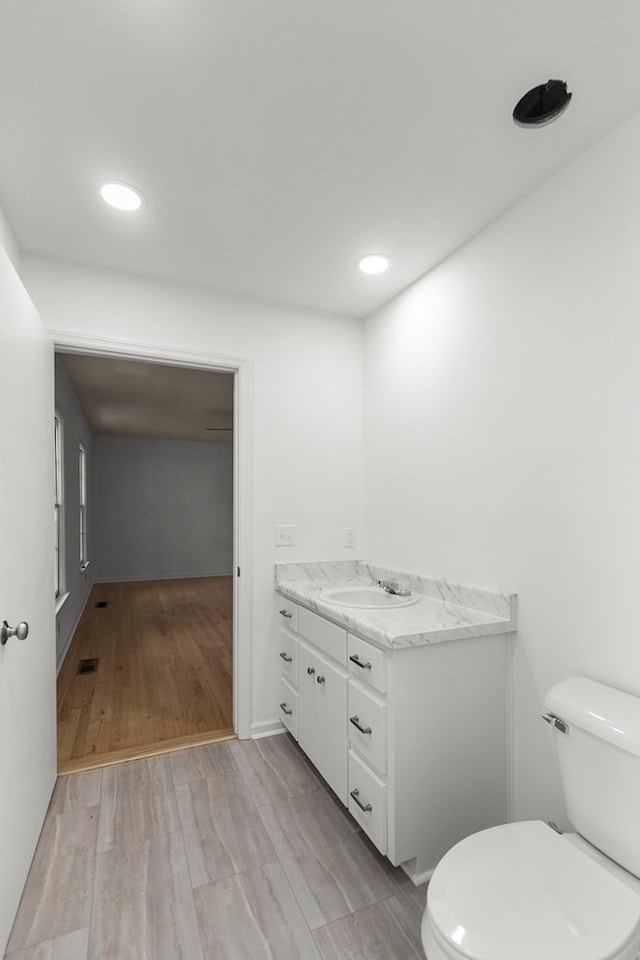 1700 Randall Rd, Dothan, AL 36303 - bathroom with toilet, vanity, wood finished floors, and recessed lighting