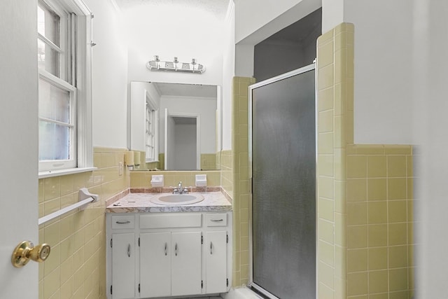 1700 Randall Rd, Dothan, AL 36303 - full bathroom featuring tile walls, vanity, a stall shower, and wainscoting