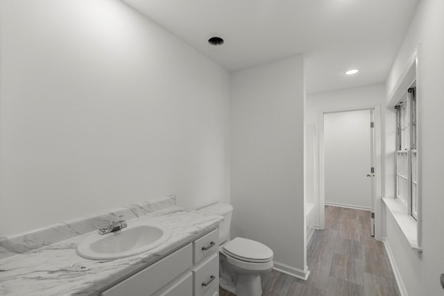 1700 Randall Rd, Dothan, AL 36303 - bathroom featuring toilet, a bathtub, vanity, wood finished floors, and baseboards