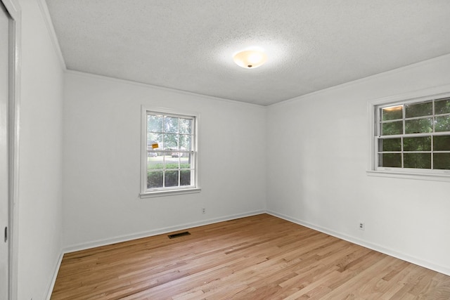 1700 Randall Rd, Dothan, AL 36303 - spare room with a textured ceiling, light wood finished floors, baseboards, and crown molding