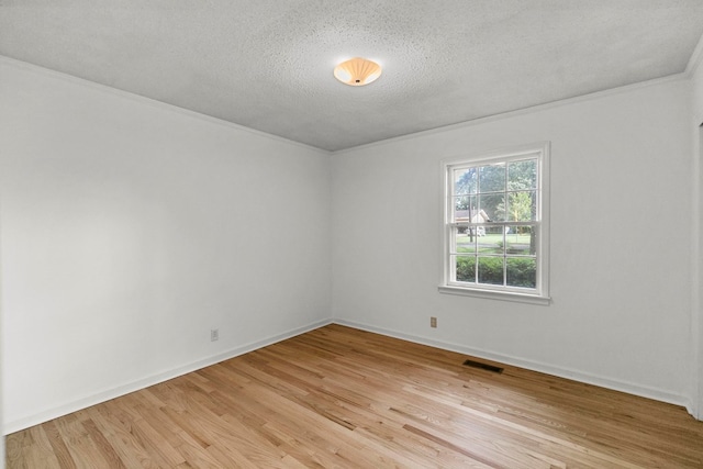 1700 Randall Rd, Dothan, AL 36303 - spare room featuring light wood-style floors, a textured ceiling, crown molding, and baseboards
