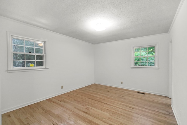1700 Randall Rd, Dothan, AL 36303 - unfurnished room with a textured ceiling, ornamental molding, light wood finished floors, and baseboards