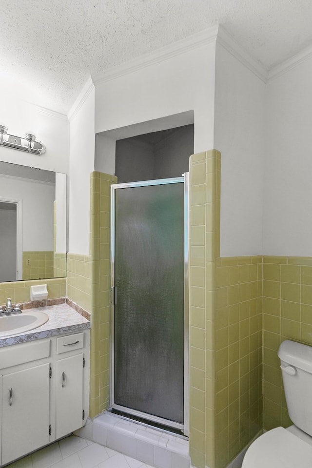 1700 Randall Rd, Dothan, AL 36303 - full bath featuring tile walls, ornamental molding, vanity, toilet, and a stall shower
