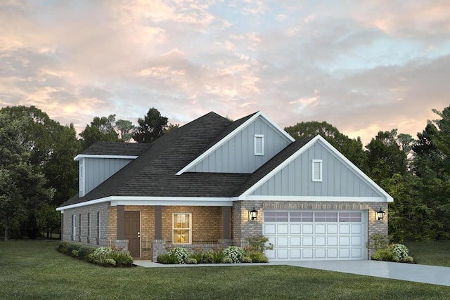 view of front of house with brick siding, concrete driveway, a garage, a front yard, and board and batten siding