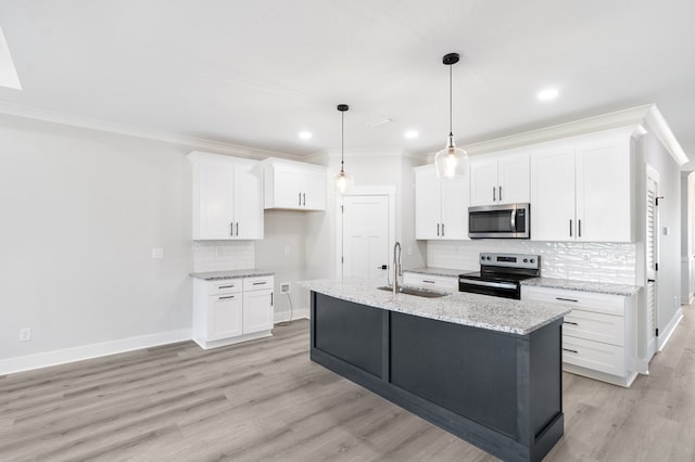 kitchen with a sink, white cabinetry, electric range oven, stainless steel microwave, and a center island with sink