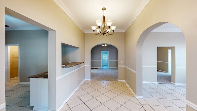 hallway featuring light tile patterned floors, an inviting chandelier, and ornamental molding