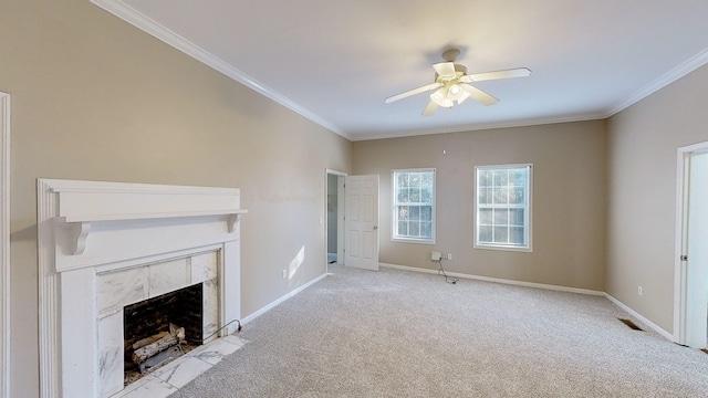 unfurnished living room featuring ceiling fan, light colored carpet, a tile fireplace, and crown molding