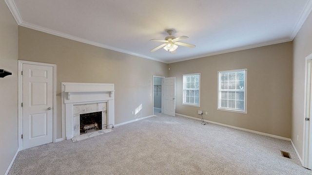 unfurnished living room with ceiling fan, light colored carpet, a tile fireplace, and ornamental molding