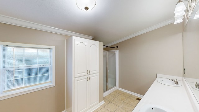 laundry area with sink, crown molding, and light tile patterned flooring