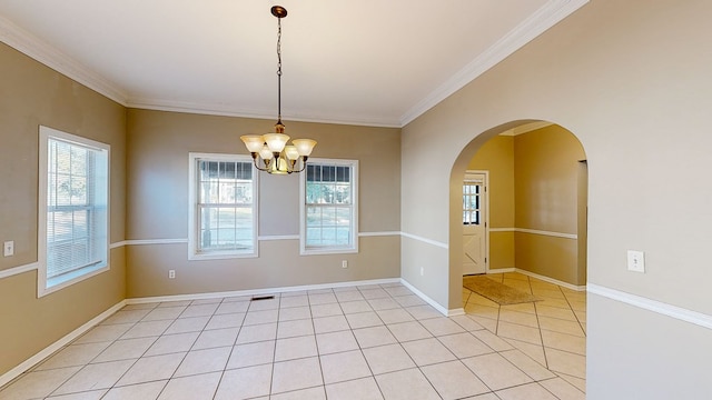 tiled empty room featuring ornamental molding and a chandelier