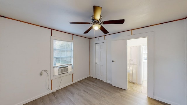 unfurnished bedroom featuring light wood-type flooring, ceiling fan, a closet, and cooling unit