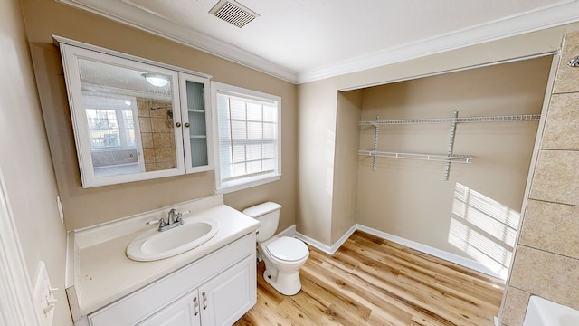 bathroom with toilet, crown molding, wood-type flooring, and vanity