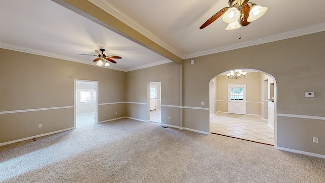 carpeted empty room with ceiling fan with notable chandelier, a wealth of natural light, and crown molding