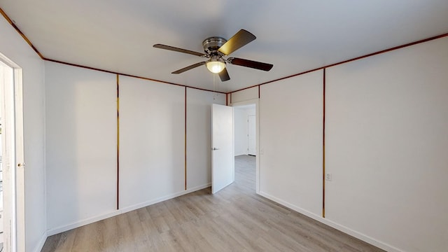 unfurnished bedroom featuring ceiling fan, a closet, and light wood-type flooring