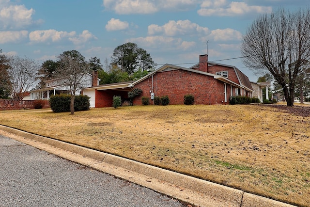 view of side of home featuring a yard