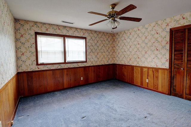 spare room featuring ceiling fan and light colored carpet