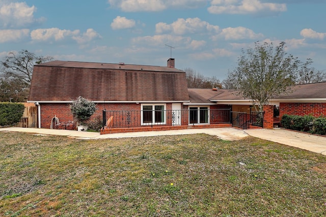 back of house with a lawn