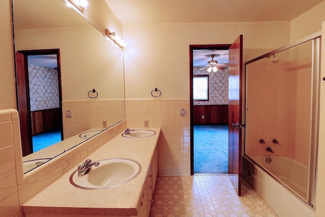 bathroom featuring vanity, tiled shower / bath combo, tile patterned floors, and tile walls