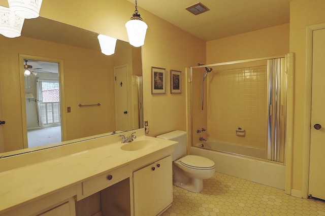 full bathroom with vanity, tiled shower / bath combo, and toilet