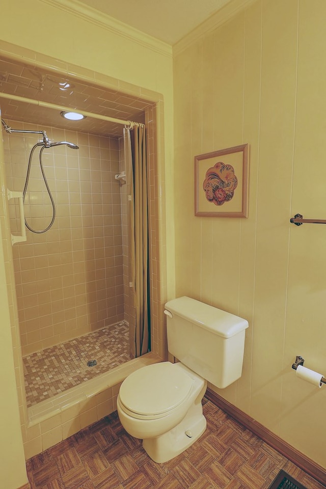 bathroom with ornamental molding, parquet flooring, toilet, and a shower with curtain