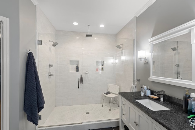 bathroom with crown molding, tile patterned flooring, vanity, and walk in shower