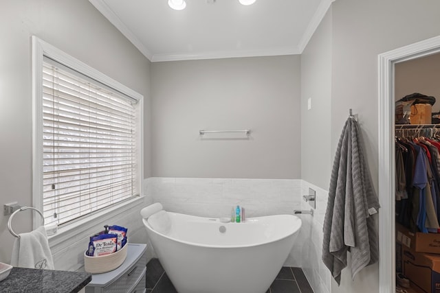 bathroom with tile patterned flooring, a bathtub, ornamental molding, and tile walls