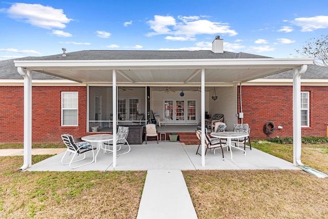 back of property featuring a patio area, ceiling fan, and a yard