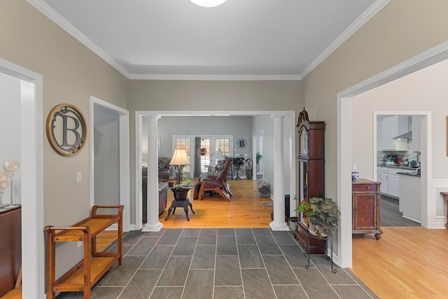 hall with ornate columns, french doors, and ornamental molding