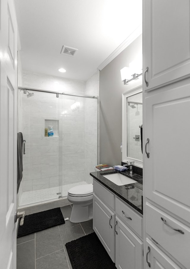 bathroom with walk in shower, ornamental molding, vanity, tile patterned flooring, and toilet