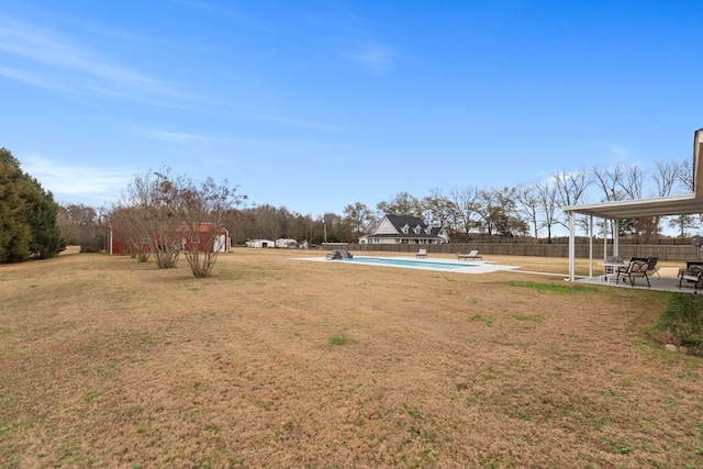 view of yard featuring a fenced in pool and a patio area