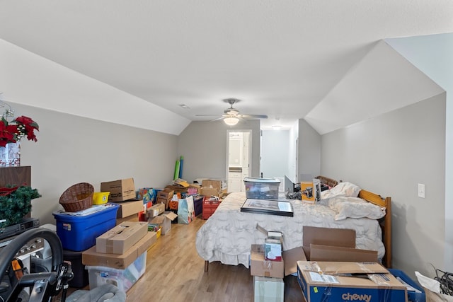 interior space with ceiling fan, light hardwood / wood-style floors, and vaulted ceiling