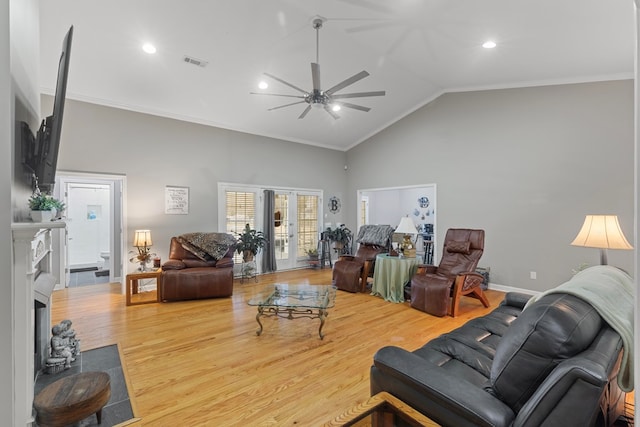 living room featuring hardwood / wood-style floors, high vaulted ceiling, french doors, ceiling fan, and ornamental molding