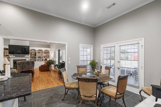 dining space featuring hardwood / wood-style flooring and crown molding