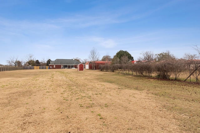 view of yard featuring a rural view and a shed