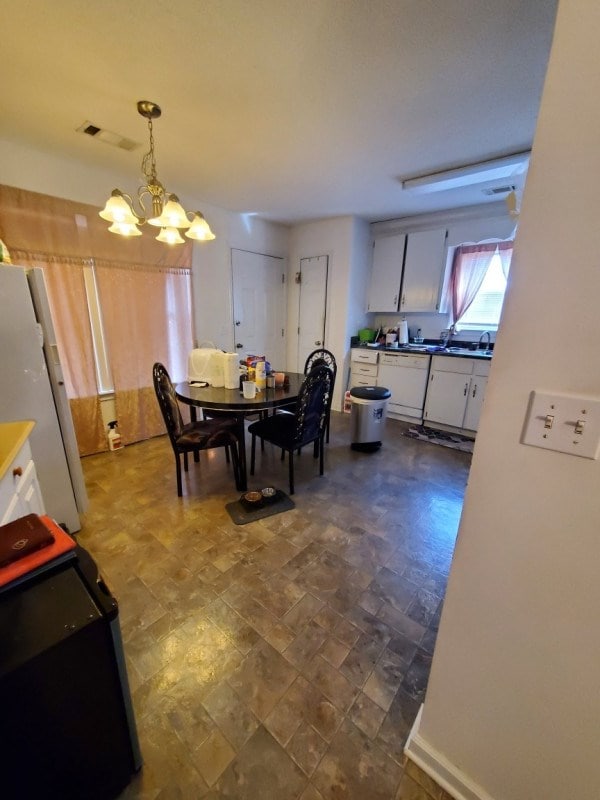 dining space featuring a notable chandelier