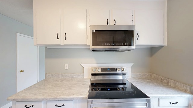806 County Road 23, Skipperville, AL 36374 - kitchen with stainless steel appliances, light countertops, and white cabinets
