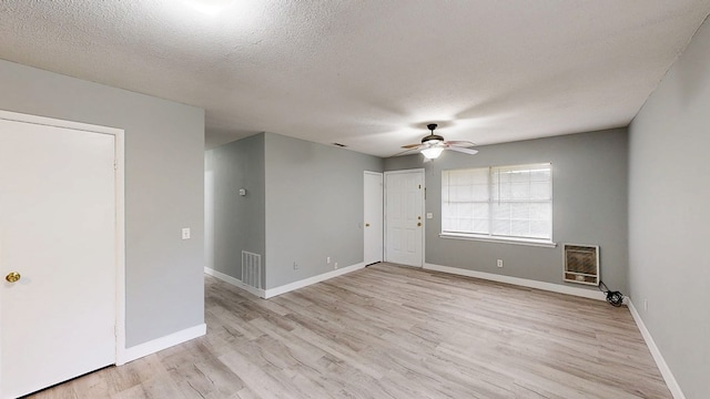 806 County Road 23, Skipperville, AL 36374 - empty room with a ceiling fan, light wood finished floors, a textured ceiling, and heating unit