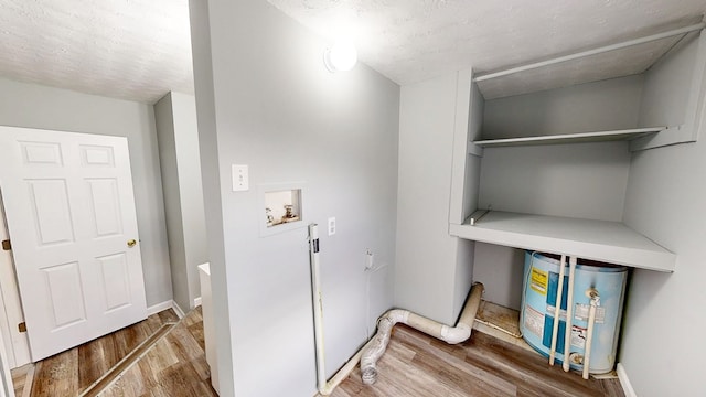 806 County Road 23, Skipperville, AL 36374 - laundry room with hookup for a washing machine, wood finished floors, and water heater