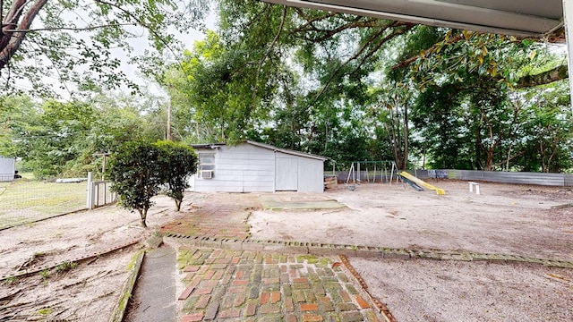 806 County Road 23, Skipperville, AL 36374 - view of yard with a playground, an outdoor structure, and view of wooded area