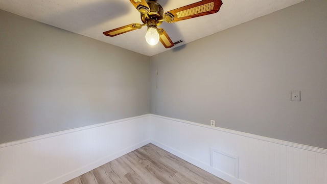 806 County Road 23, Skipperville, AL 36374 - unfurnished room featuring light wood-style flooring, ceiling fan, and a wainscoted wall