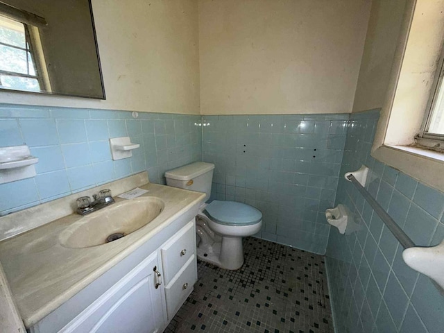 230 Sharon Ct, Ozark, AL 36360 - half bathroom featuring tile walls, vanity, tile patterned floors, and a wainscoted wall