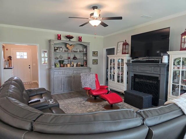 526 Ridgeland Rd, Dothan, AL 36301 - living room with a fireplace, ceiling fan, ornamental molding, wood finished floors, and baseboards