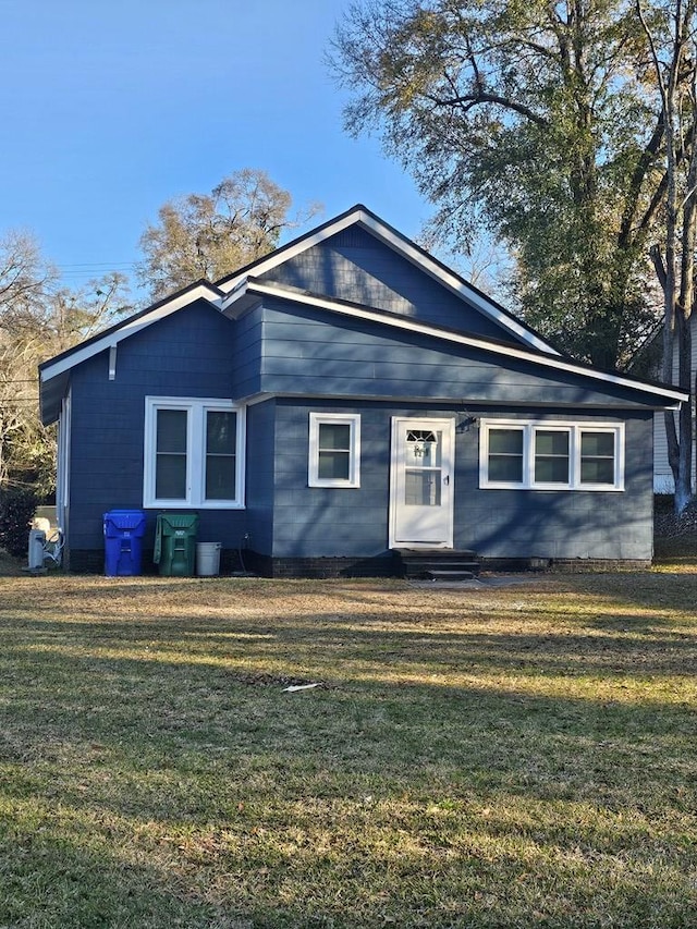 view of front facade with a front lawn and entry steps